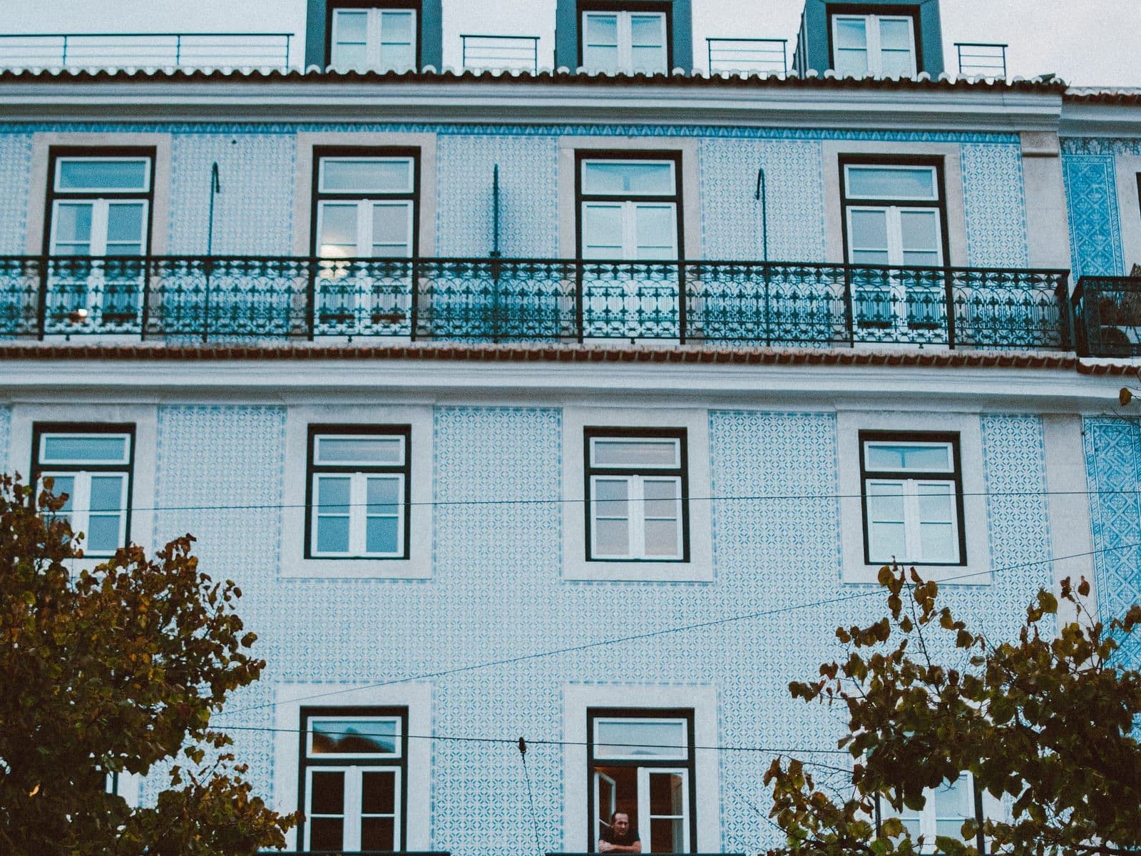 Blue tiled apartment building with iron balconies